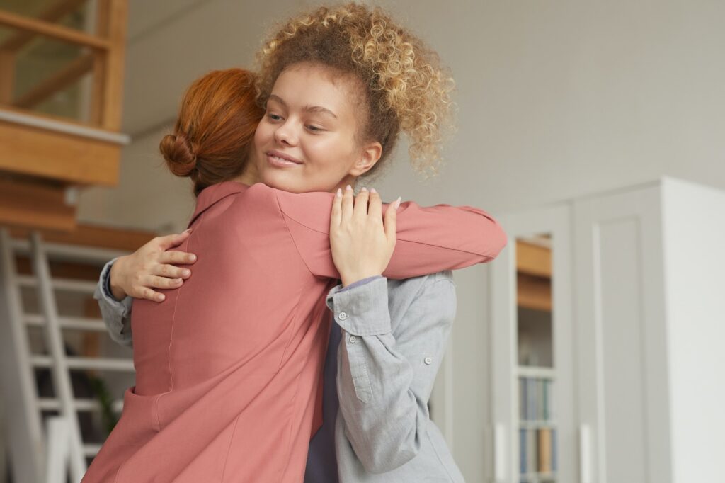 Friendly hugging at meeting